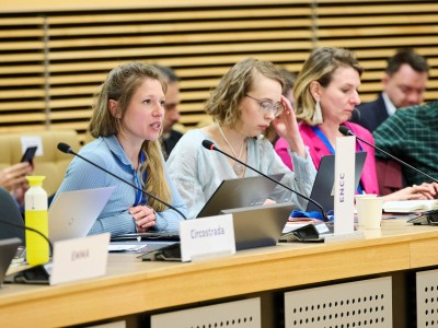 A young woman speaking at a panel