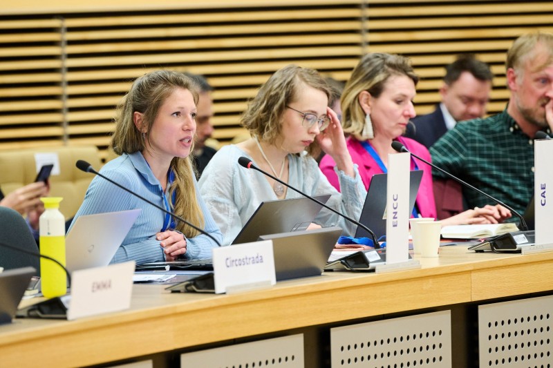 A young woman speaking at a panel