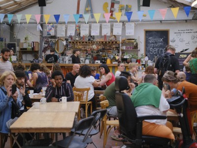 Many people doing different activities at the bar of a socio-cultural centre