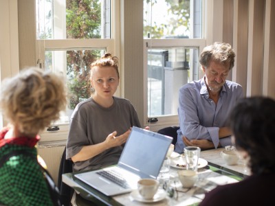 four people sitting at a desk working