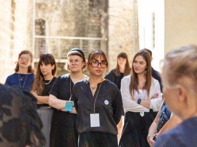 A group of young people at a workshop, outdoors