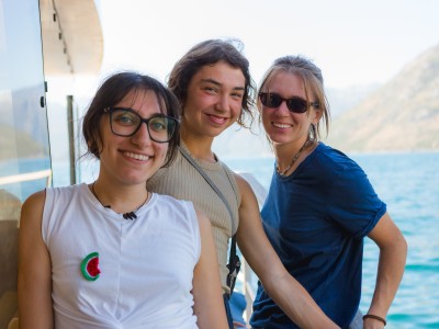 Three women on a boat, smiling