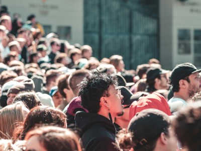 a crowd attending an event outdoors during a sunny day