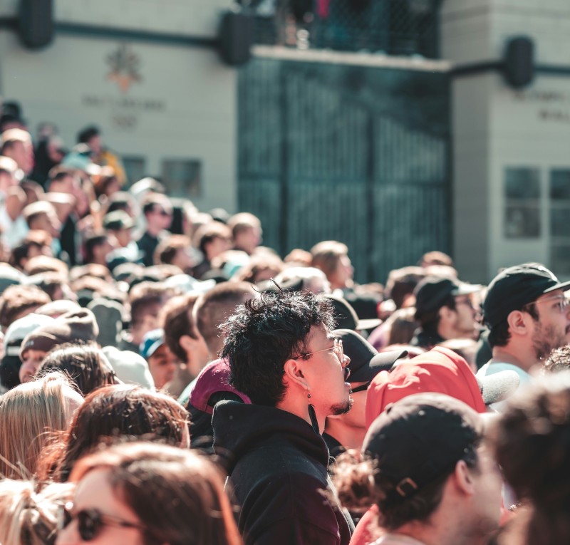 a crowd attending an event outdoors during a sunny day