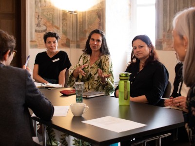 A group of women discussing at a table